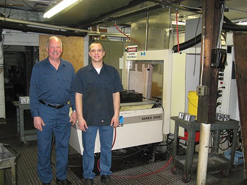Mark and John Lewkowicz in front of an automatic pallet changer