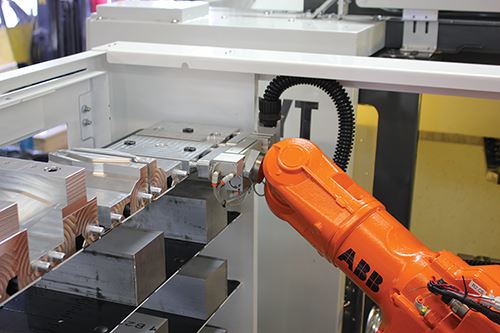 a robot arm picks up a soft-jaw tooling
