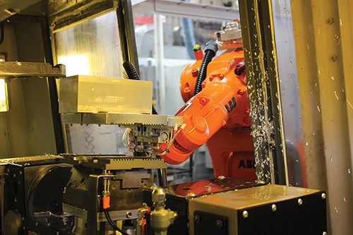robot arm placing workpiece into machining center