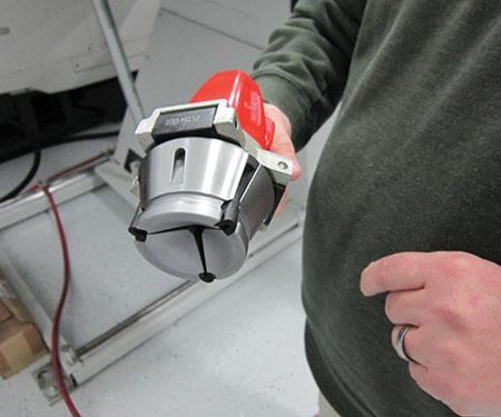 man holding a new collet in a quick-change system