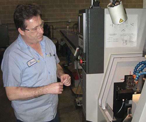 John Groth programming a CNC lathe