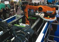 A robot mounted to an injection molding machine