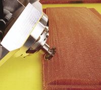Six -axis ultrasonic cutter incorporates a disc to sculpt  honeycomb air foil shape.