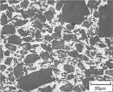 A photomicrograph of an AlSiC composite shows the silicon carbide particles (dark) surrounded by the aluminum alloy matrix (light).