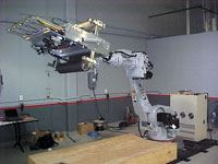 Motoman UP200 robot with 610-mm/24-inch PFE, set up for prepreg material (system shown with arm partially extended).