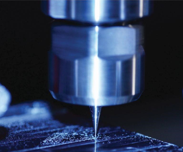 A close-up of a tiny cutting tool in the midst of a trochoidal tool path during machining of channels into titanium plates for an optical application on a Kern Evo machining center. 