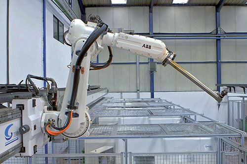 The top-mounted, linear-axis ABB 6620LX robot serves four CNC machining centers