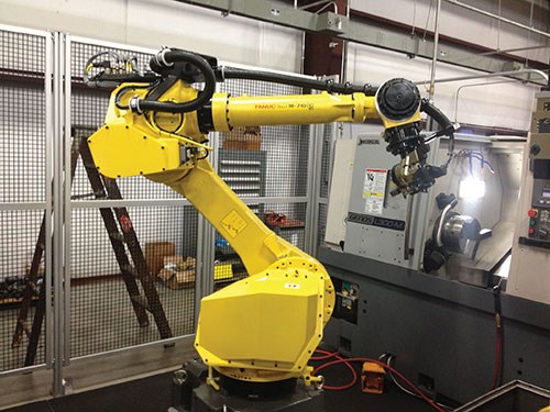 The FANUC robot uses two, three-jaw gripper units to load and unload two parts at a time.