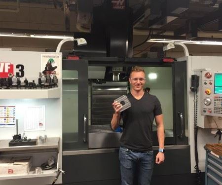 Mechanical engineer Dakota Bass is seen here with one of the machining centers used to manufacture satellite launchers at CubeSat.