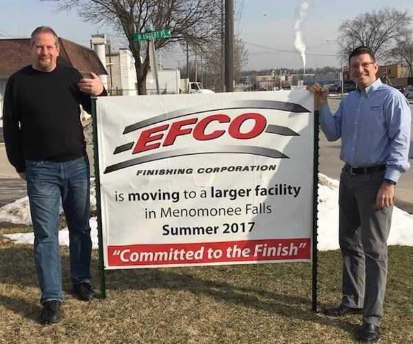 Terry Schultz and Mike Budgins stand by the sign on 124th Street, alerting their customers to the changes ahead. 