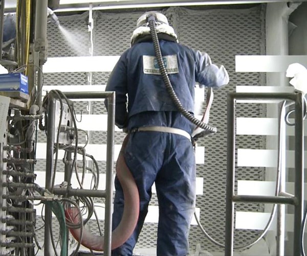 men painting aluminum