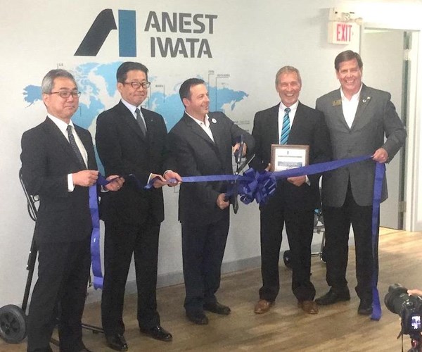 Company officials cut the ribbon to open the new facility.