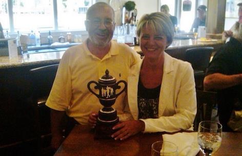 Paul Frank, Palmetto President, with Wendi Smith and Bill Smith Memorial Tournament trophy.