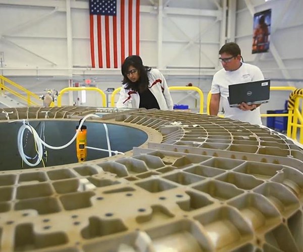 Boeing employees work on the CST