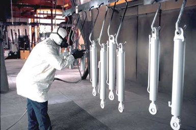 man spray painting a part