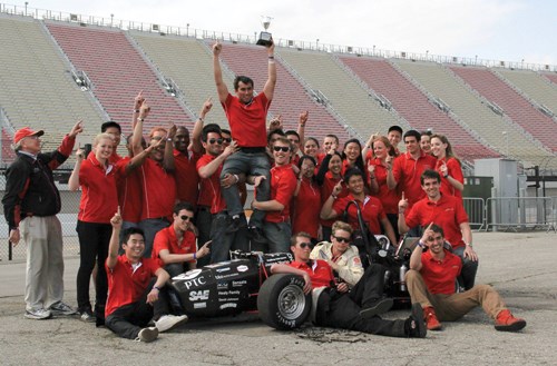 students winning and holding a trophy