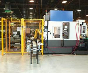 Automated cell comprised of a Tongtai machining center with rotary pallet changer, a FANUC robot and a conveyer system