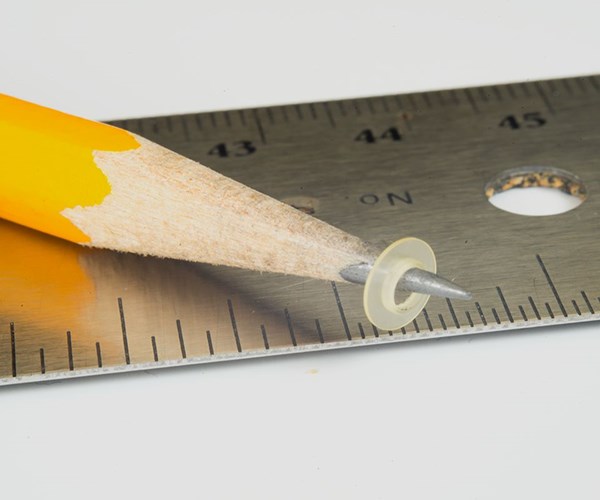 pencil with micro part balancing on it
