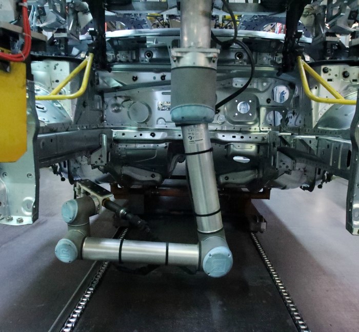 Universal Robots UR10 performs a screwdriving operation underneath a vehicle.