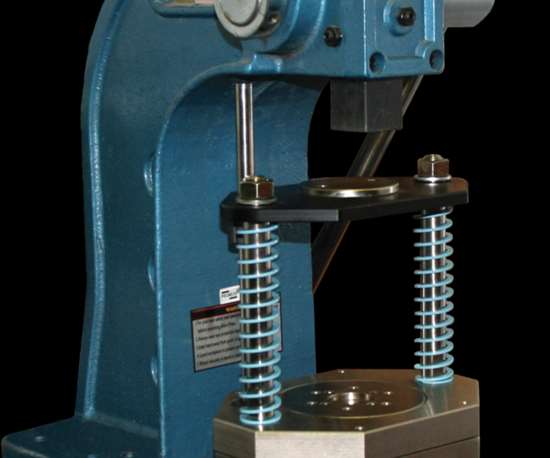 The Smart Press Frame, shown in place on a manual arbor press, monitors force and position.