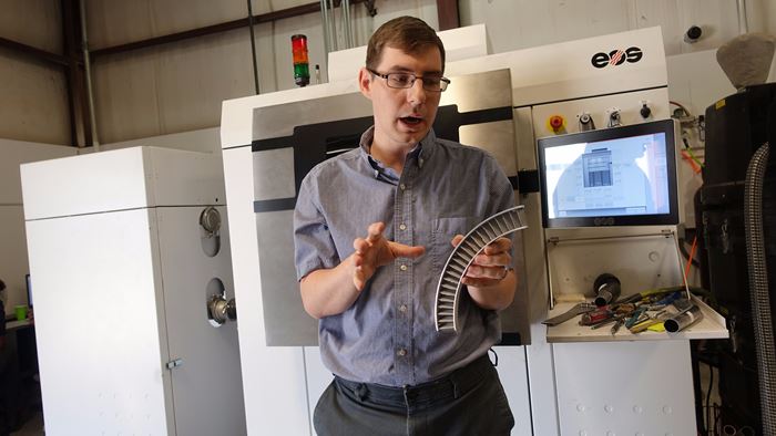 Jacob Nuechterlein with EOS machine and metal matrix composite part