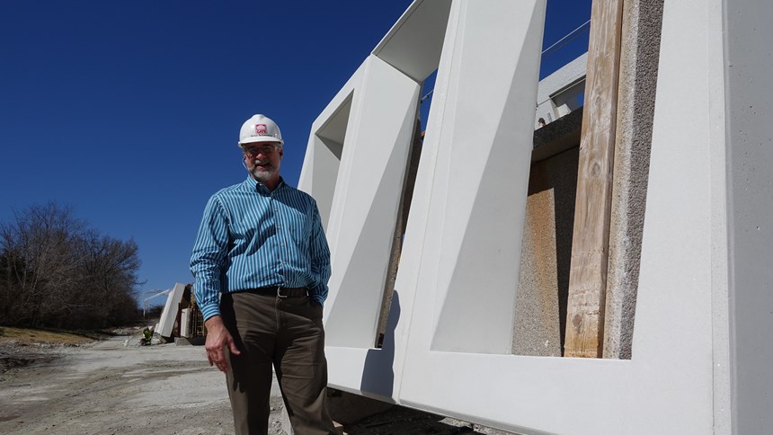 Steve Schweitzer in front of precast concrete punched windows