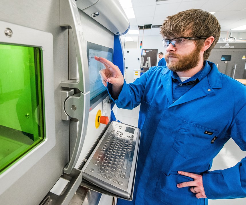 Carpenter Technology engineer running a metal 3D printing system
