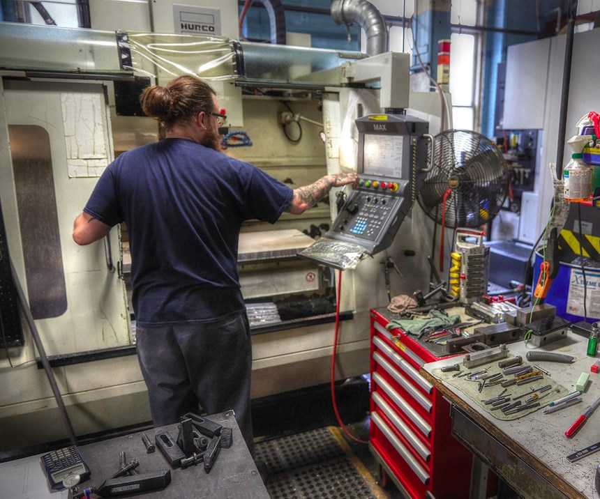 A&M Tool and Design employee programming a CNC