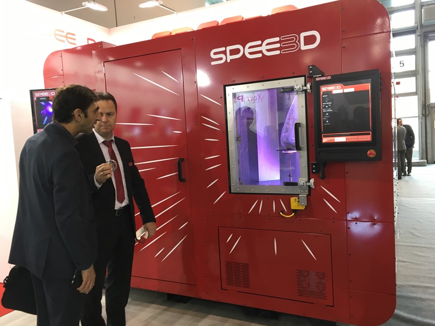 two people looking at spee3d machine