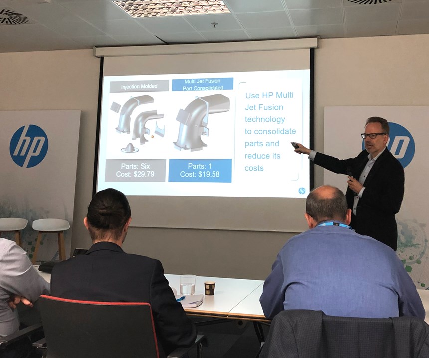 Philipp Jung, chief strategy officer, HP, shows an air intake part 