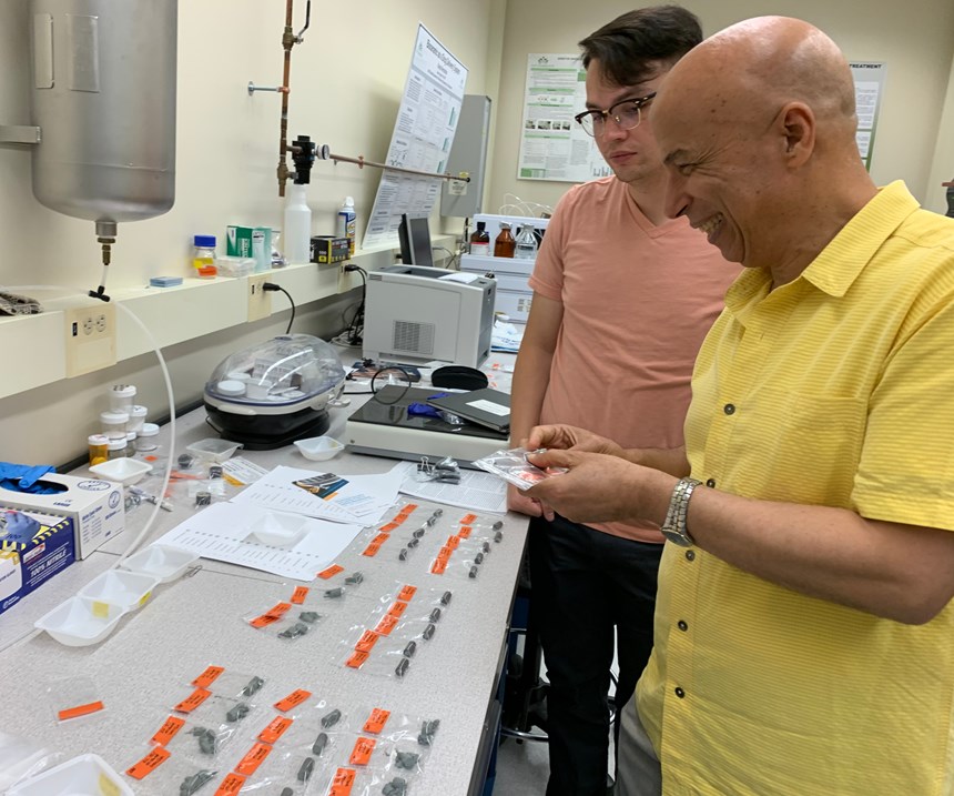 Dr. Ahmed El-Ghannam examines samples that have been used to validate the crystal-growth method of bonding SiC