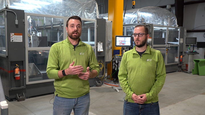 AES cofounders Andrew Bader and Austin Schmidt, with Big Area Additive Manufacturing machines are in the background