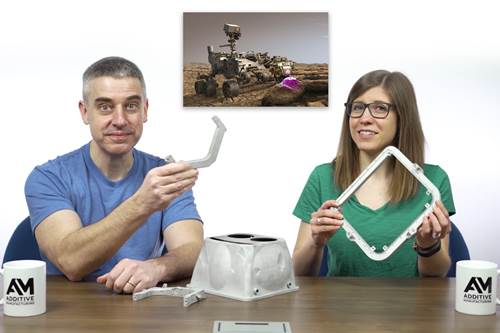 A screenshot of a Cool Parts episode, with Pete and Stephanie holding parts that were used for the Curiosity rover