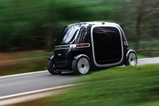 electric car moving on road, surrounded by trees