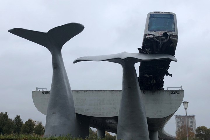 composite whale statue catches runaway train car