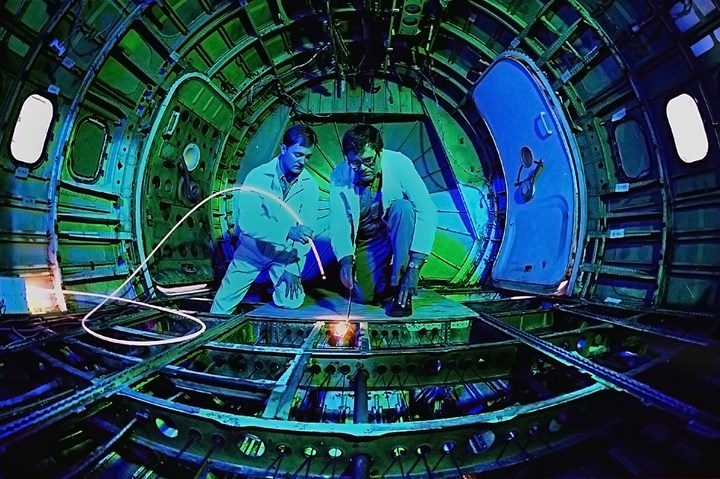 Sandia National Laboratories’ Dennis Roach (left) and Ken Harmon (retired) examine the inside of a Boeing 737 for long-term structural fatigue.