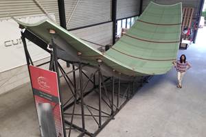 Curved composite sandwich panel production on an adaptive mold