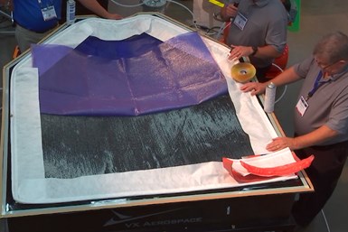 team assembling a vacuum-infusion on a UAV wingskin part