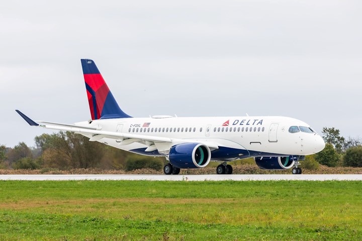 Delta A220 aircraft sitting on the runway.