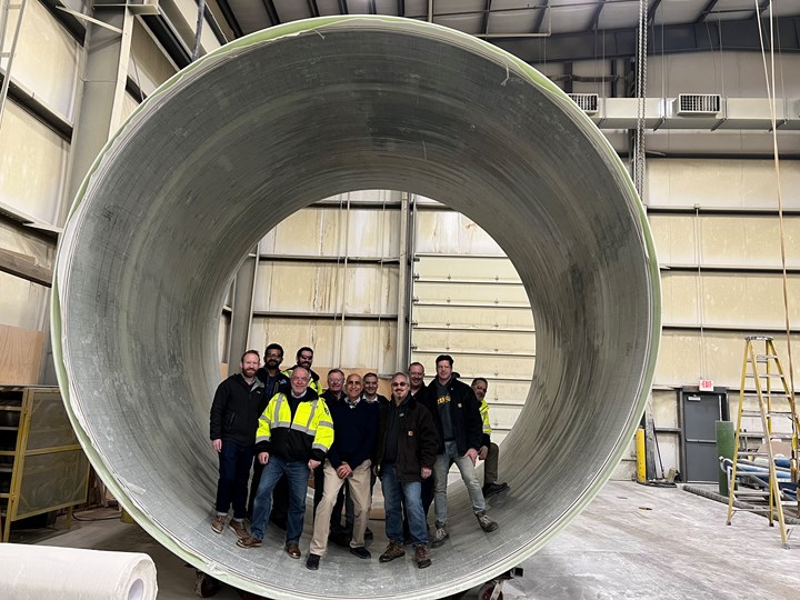16 foot diameter sewage pipe, men inside