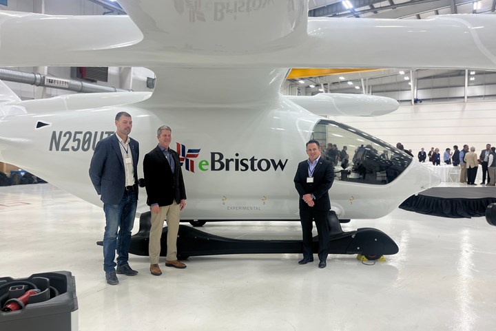 Beta Technologies and Bristow execs stand in front of Alia aircraft.