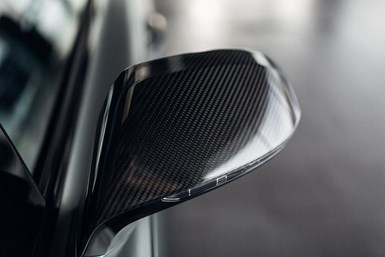 Carbon fiber detail on car mirror.