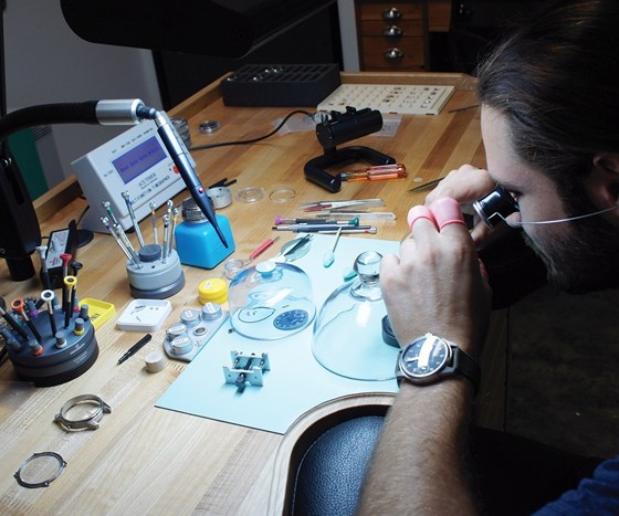Cameron Weiss assembles a watch with machined hand tools