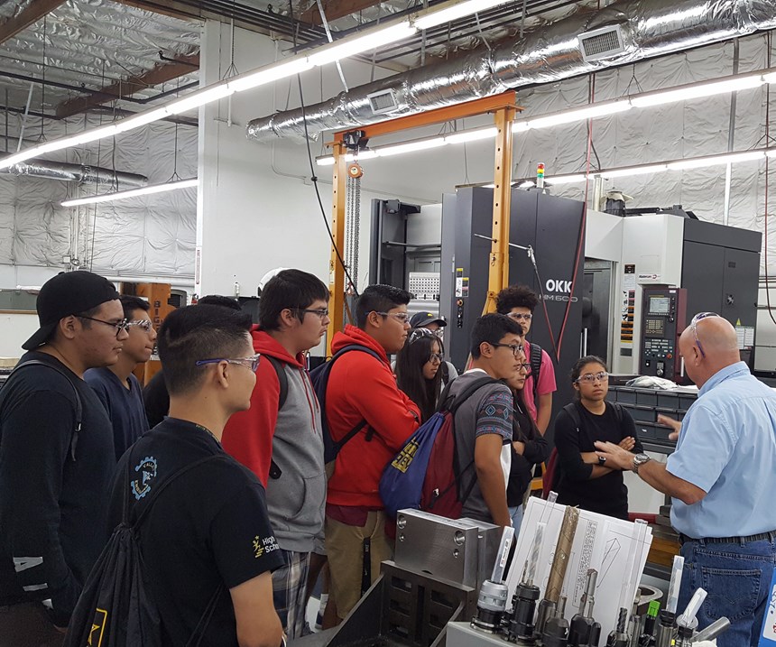 Ray Shapland, project engineering manager, talks about CNC programming with a group of students from Lou Vue’s class at Valley High School, Santa Ana