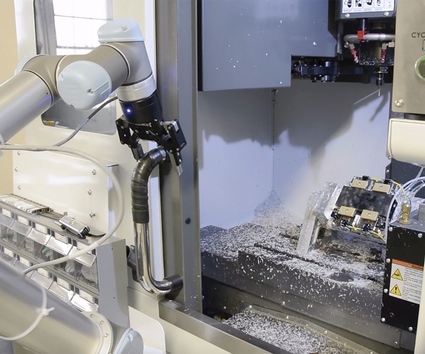 robot opening the door of a machining center