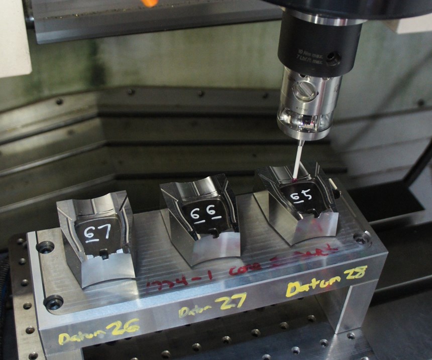 A measuring probe conducts an in-process inspection within the workzone of a vertical machining center. 