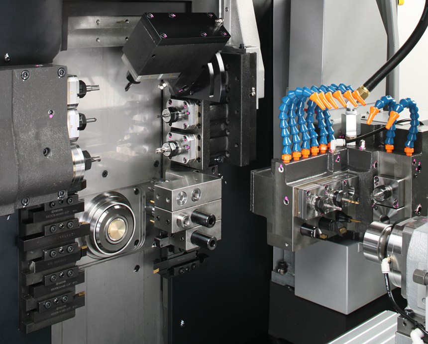 Main spindle, subspindle and various tool posts are visible within the workzone of this Swiss-type lathe, a machine designed to machine parts complete in one setup. 