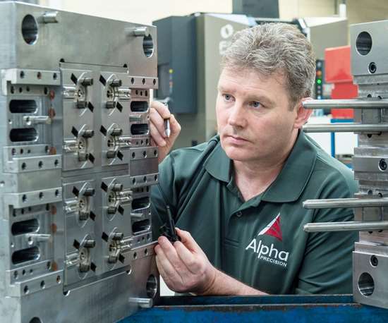 Brendan Feely of Alpha Precision checks an injection mold