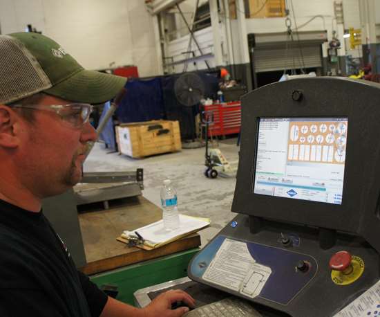 Aaron Bazydlo, the waterjet’s primary operator, demonstrates how the system’s software eases the work of locating and aligning multiple parts on the table. 