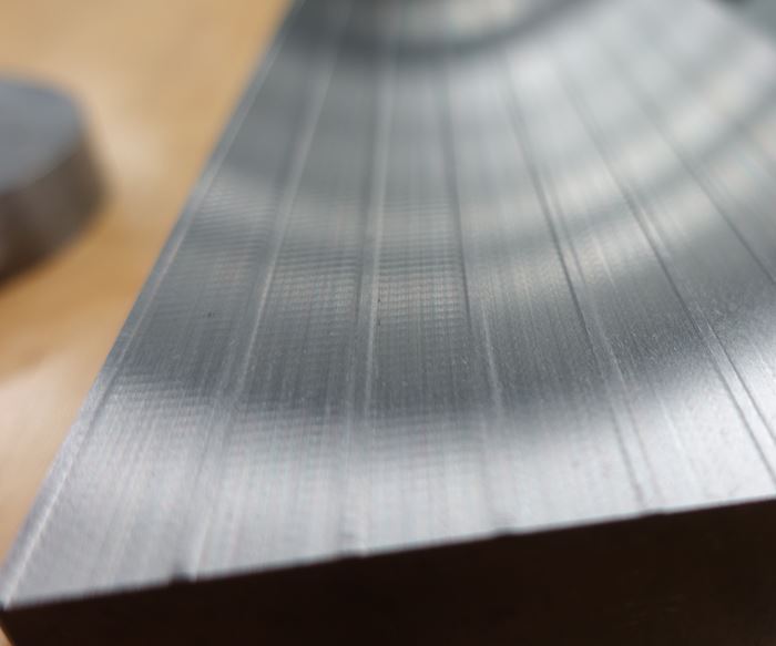 metal workpiece machined by surface grinding showing chatter on some passes